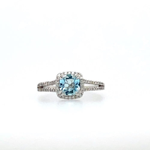 This 14 Karat White Gold Split Shank Ring Features a .85 Carat Blue Aquamarine Gemstone Set with Double Prongs, Surrounded by a Diamond Halo and Even More Diamonds Down the Shank of the Ring.  Total Diamond Weight .25dtw  Finger Size 7
