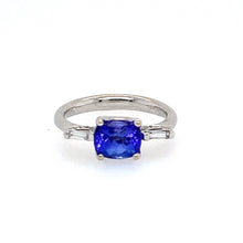 Load image into Gallery viewer, This Beautiful Bold Oval .80 Carat Tanzanite Gemstone is set Sideways in the 18 Karat White Gold Mounting with a Baguette Cut Diamond on Each Side.  Diamond Total Weight .75dtw  Finger Size 7  Total Weight 5.0 Grams   Estate Ring - Weights are Approximate 
