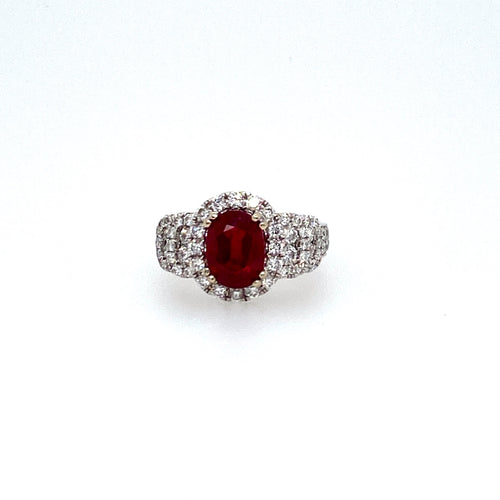 Vivid Red Describes the Color of this Oval Brilliant-Cut 2.45 Carat Burma Ruby Gemstone (GIA Certificate). The Gemstone is Embellished with a Diamond Halo and Diamonds on the Sides Totaling 1.18 Carats of Sparkle. Finger Size 6.5
