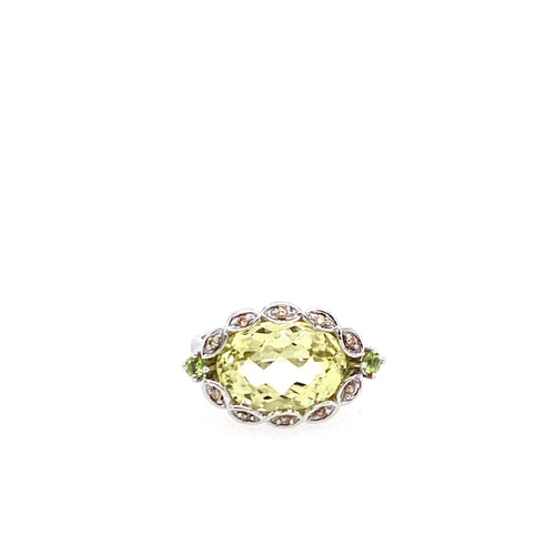 This 14 Karat White Gold Ring features a Green Quartz with a twisted Diamond Bezel Halo.  Finger Size 7