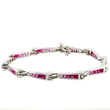 Load image into Gallery viewer, Show off your sophisticated style with this 18 Karat White Gold Bracelet. Each link graduates in color from Genuine Ruby gemstones to Pink Sapphire Gemstones totaling 3.00 total Carats. the bracelet holds even more sparkle with .33ctw of Diamonds. The hidden safety provides that extra security.  Length is 7&quot;  Total weight is 14.9 Grams  
