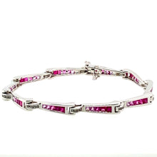 Load image into Gallery viewer, Show off your sophisticated style with this 18 Karat White Gold Bracelet. Each link graduates in color from Genuine Ruby gemstones to Pink Sapphire Gemstones totaling 3.00 total Carats. the bracelet holds even more sparkle with .33ctw of Diamonds. The hidden safety provides that extra security.  Length is 7"  Total weight is 14.9 Grams