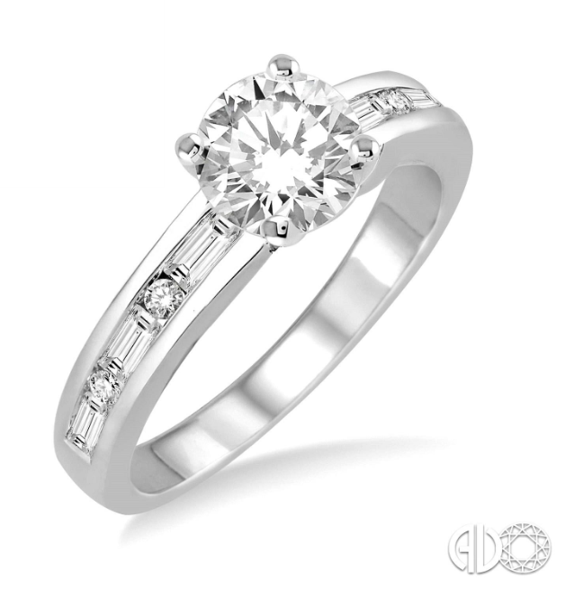Enchant the love of your life with this exquisite diamond semi-mount ring. Styled in glinting 14 Karat White Gold, the shank of the ring is embellished with 10 scintillating baguette and round diamonds, perfectly channel set. This ring is designed to accommodate your choice of center stone ranging from .85 carat to 1.20 carat (sold separately, not included in price). The total diamond weight is 1/3ctw.  Center stone sold separately, not included in price  Finger size is 6.5 