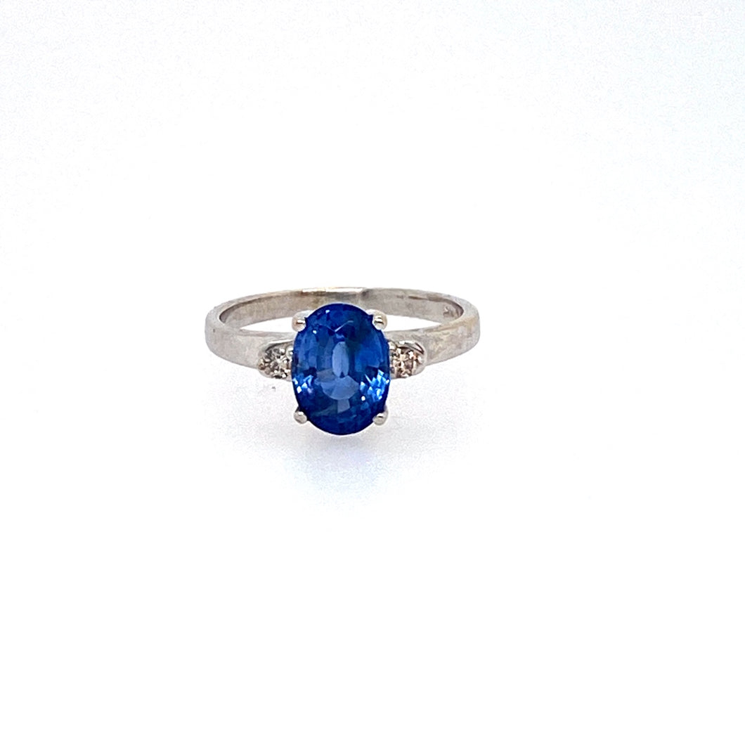 This 14 Karat White Gold Estate Ring Features a 2.44 Carat Oval Tanzanite Gemstone with 2 Diamonds set on Each Side.  Total Weight is 2.6 Grams  Finger Size 5.5  Estate Ring - all Weights are Approximate