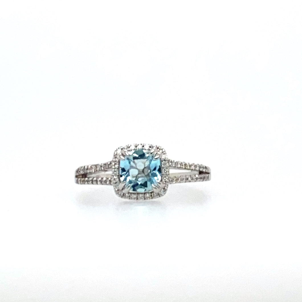 This 14 Karat White Gold Split Shank Ring Features a .85 Carat Blue Aquamarine Gemstone Set with Double Prongs, Surrounded by a Diamond Halo and Even More Diamonds Down the Shank of the Ring.  Total Diamond Weight .25dtw  Finger Size 7