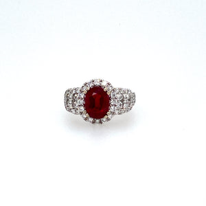 Vivid Red Describes the Color of this Oval Brilliant-Cut 2.45 Carat Burma Ruby Gemstone (GIA Certificate). The Gemstone is Embellished with a Diamond Halo and Diamonds on the Sides Totaling 1.18 Carats of Sparkle. Finger Size 6.5