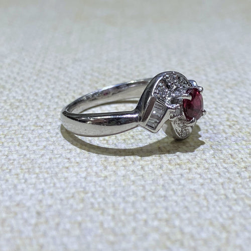 This Gorgeous Platinum Ruby and Diamond Estate Ring features a .45 carat Ruby gemstone, prong set in the center, with .15ctw of Baguette and Round Accent Diamonds. The total weight of the ring is 7.7 Grams  Finger size is 6  Weights are Approximate 