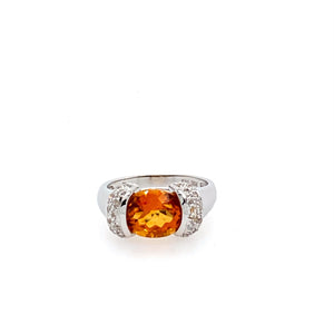 One of our favorite Citrine Rings, this 14 Karat White Gold Ring features an Oval Citrine Beautifully Faceted Gemstone  set Sideways with Diamond Accents.  The Vibrant Orange Color will Jazz up any outfit.  Finger Size 7 