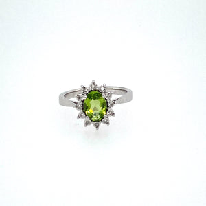 Set into this Crown Like Halo is a Pretty Green Peridot Gemstone.  .09dtw  Finger Size 7 Metal is 14 Karat White Gold