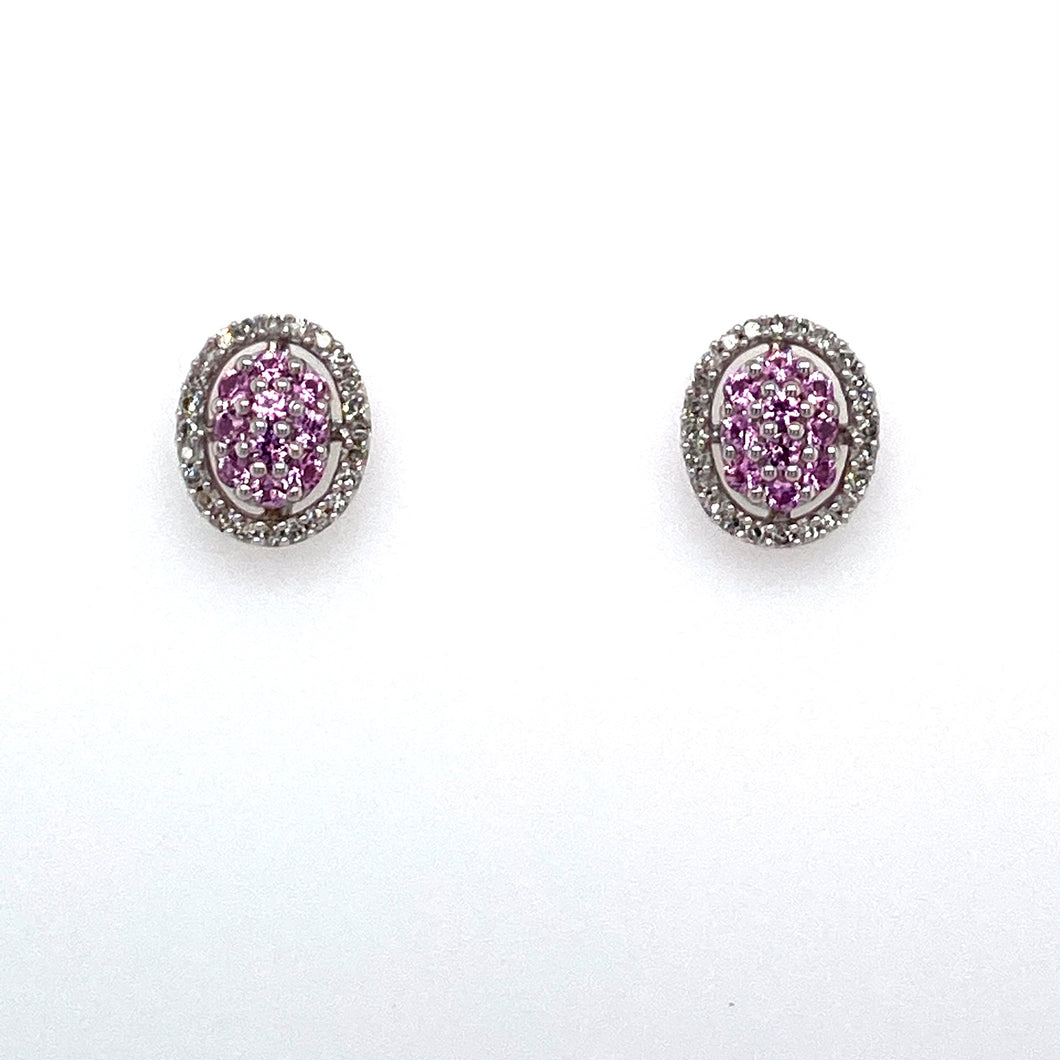 This Pair of 14 Karat White Gold Oval Earrings Feature Pink Sapphire Gemstones and White Sparkling Diamonds.  The Earrings are Secured with Posts and Push on Backs.  Total Diamond Weight .25 Carat  Total Weight 3.1 Grams