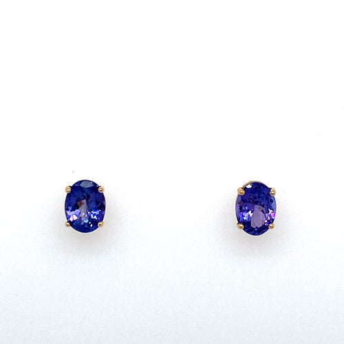 Each Earring is Set into 14 Karat Yellow Gold and Features a 1.25 Carat Oval Blue-Purple Tanzanite Gemstone. No Embellishing Needed with These Beauties, Secured with Posts and Push on Backs.  Total Gemstone Weight 2.50 Carats