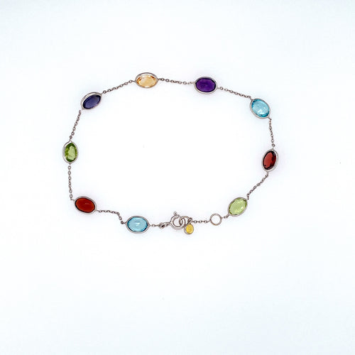 Full of Color in this 14 Karat White Gold Bracelet Featuring 7.5ctw Bezel Set Semi Precious Gemstones Like Amethyst, Blue Topaz, Citrine, Garnet, and Peridot, The Bracelet is Secured with a White Gold Spring-ring Clasp. Total Length is 7 1/2