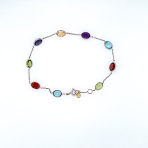Full of Color in this 14 Karat White Gold Bracelet Featuring 7.5ctw Bezel Set Semi Precious Gemstones Like Amethyst, Blue Topaz, Citrine, Garnet, and Peridot, The Bracelet is Secured with a White Gold Spring-ring Clasp. Total Length is 7 1/2"