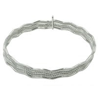 This Sterling Silver Bracelet Features 5 Rows of Bangles, with the Three Inside Bangles Featuring a Diamond-Cut Finish for added Sparkle, and 2 Polished Finished Bangles, Bound Together at just one section Giving this piece a lot of Movement within.  The Bracelet is Designed by Frederic Duclos.