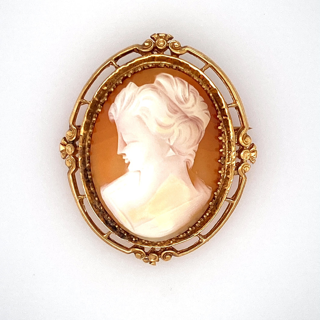 The Design of this Estate 14 Karat Yellow Gold Mounting Holding a Cameo of a Lady is One you might have Seen Your Grandma Wear. This Beautiful Cameo can Be worn as a Pin or a Pendant. Measures Approximately 47.0mm x 40.0mm  Total Weight 13.5 Grams