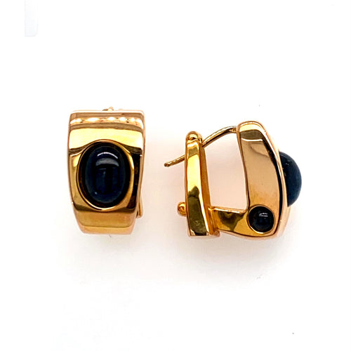 Deep Blue Oval Cabochon Sapphire Gemstones are Bezel set into the Center of Each Earring and on the bottom side of the Earring. The High Polished 14 Karat Yellow Gold Earrings are Secured with Omega Backs.  Total Weight 7.7 Grams
